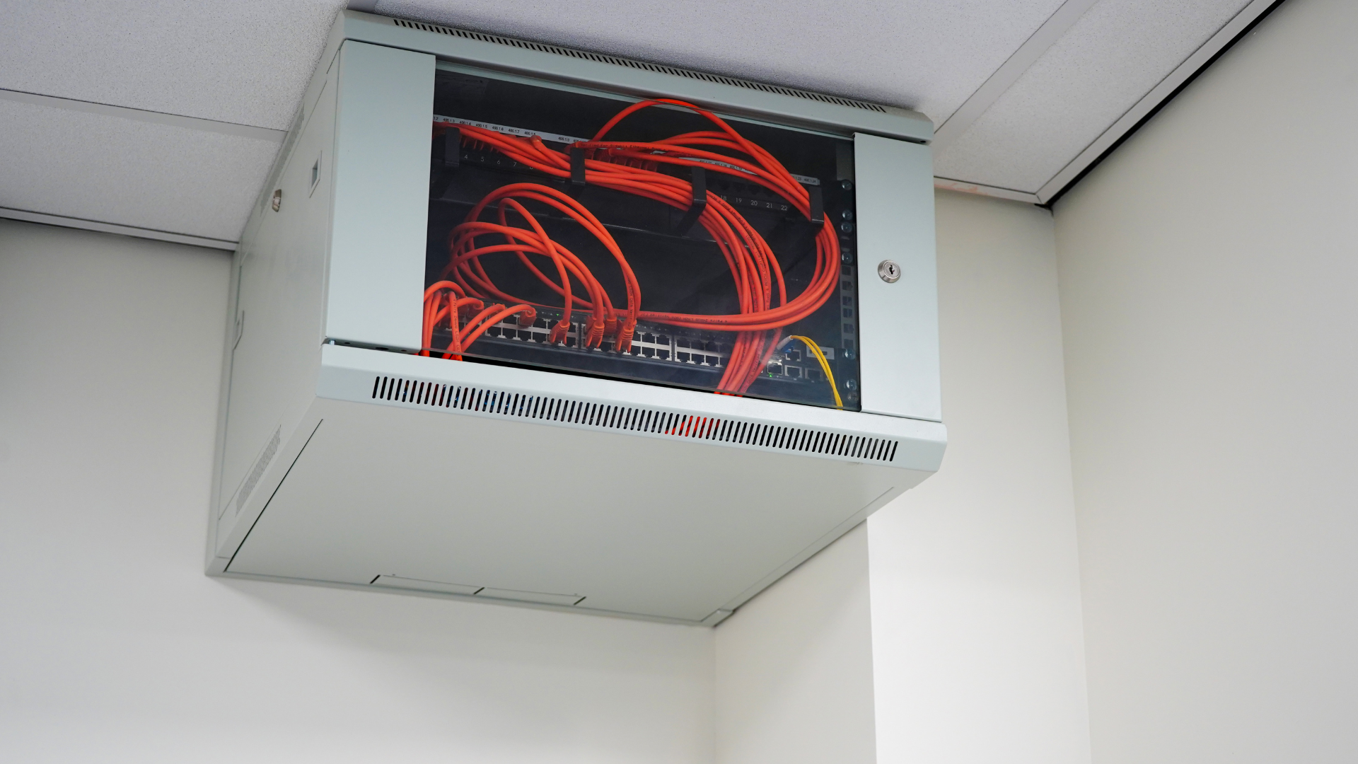 A server box with a bunch of wires coming out of it