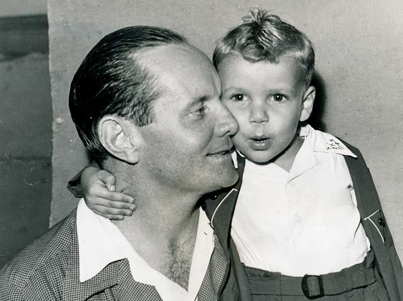 A black and white photo of a man holding a little boy