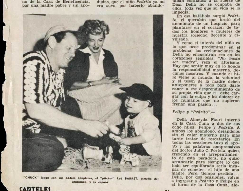 A black and white photo of a man and woman talking to a child