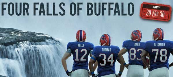 Four football players are standing in front of a waterfall