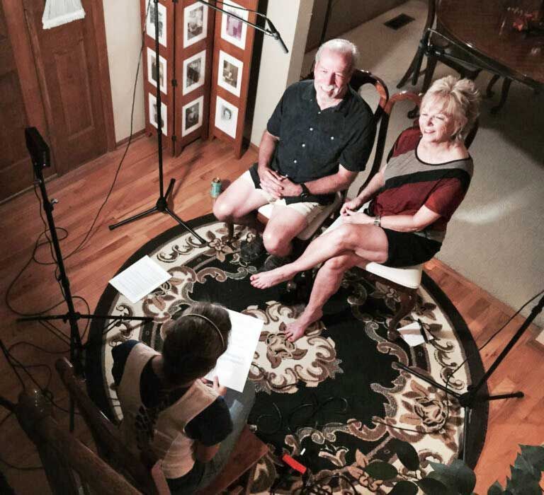 A group of people are sitting in a circle on a rug