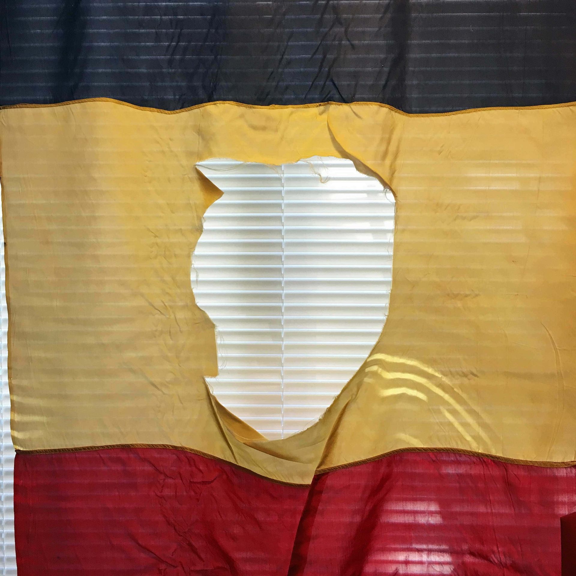 A flag with a hole in the middle of it