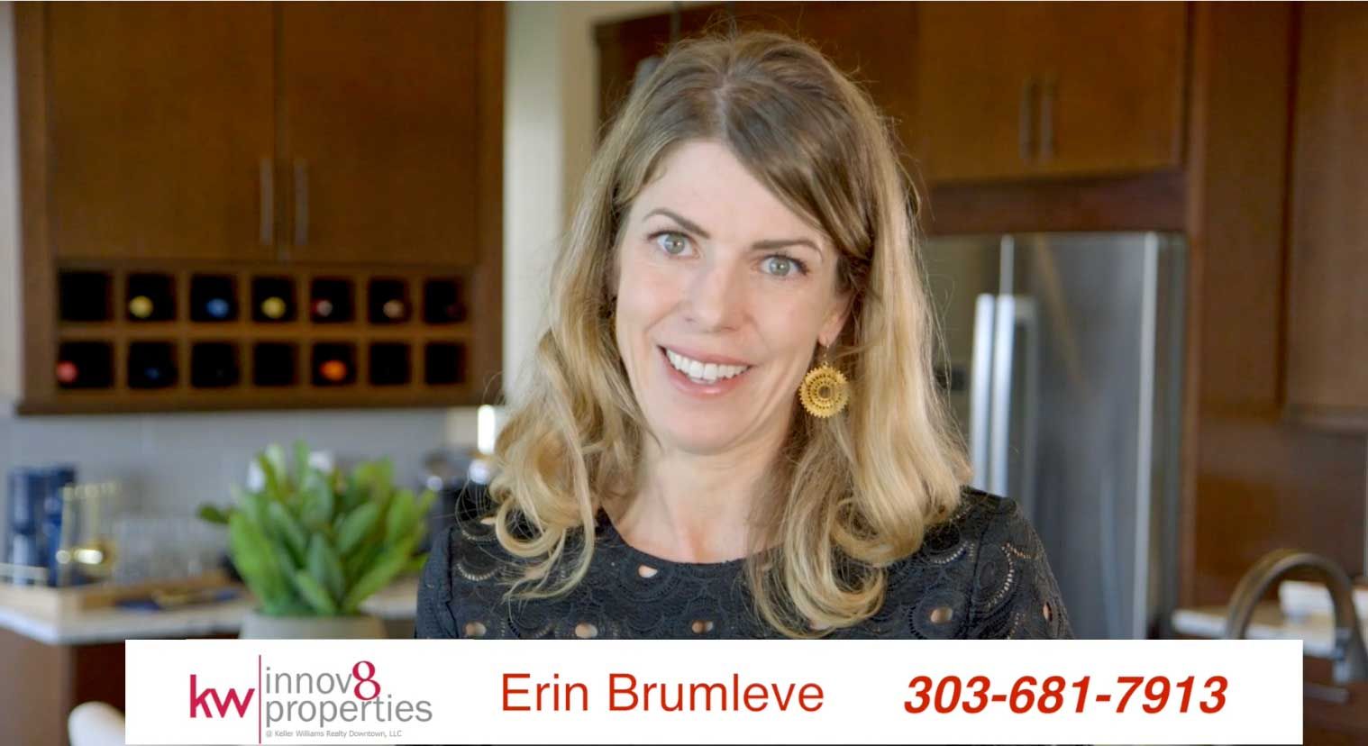 A woman is standing in a kitchen with a phone number.