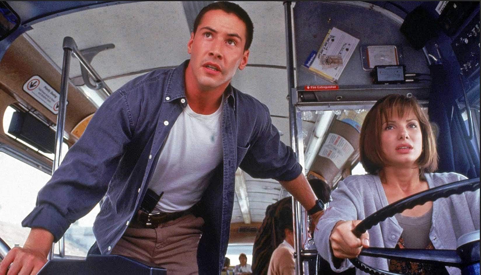 A man and a woman are sitting on a bus