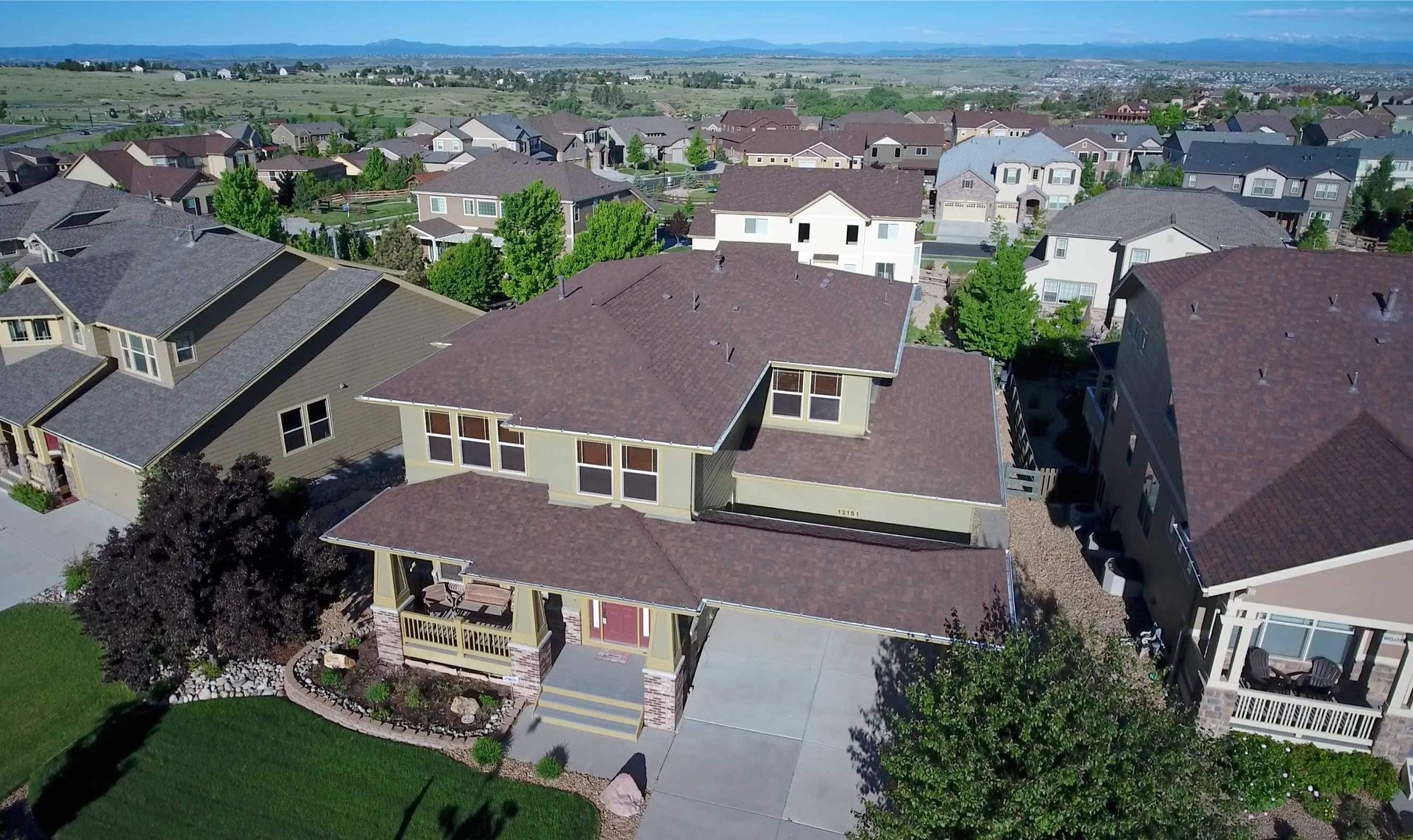 An aerial view of a house in a residential area