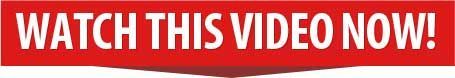 A red sign that says watch this video now