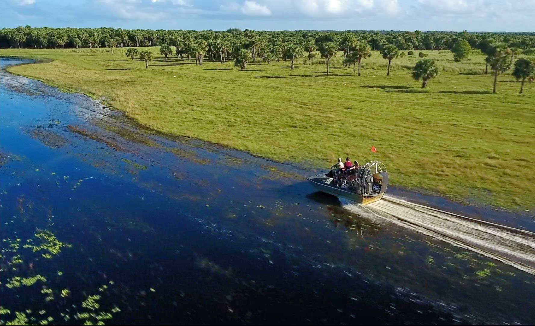 A group of people are riding a boat down a river.