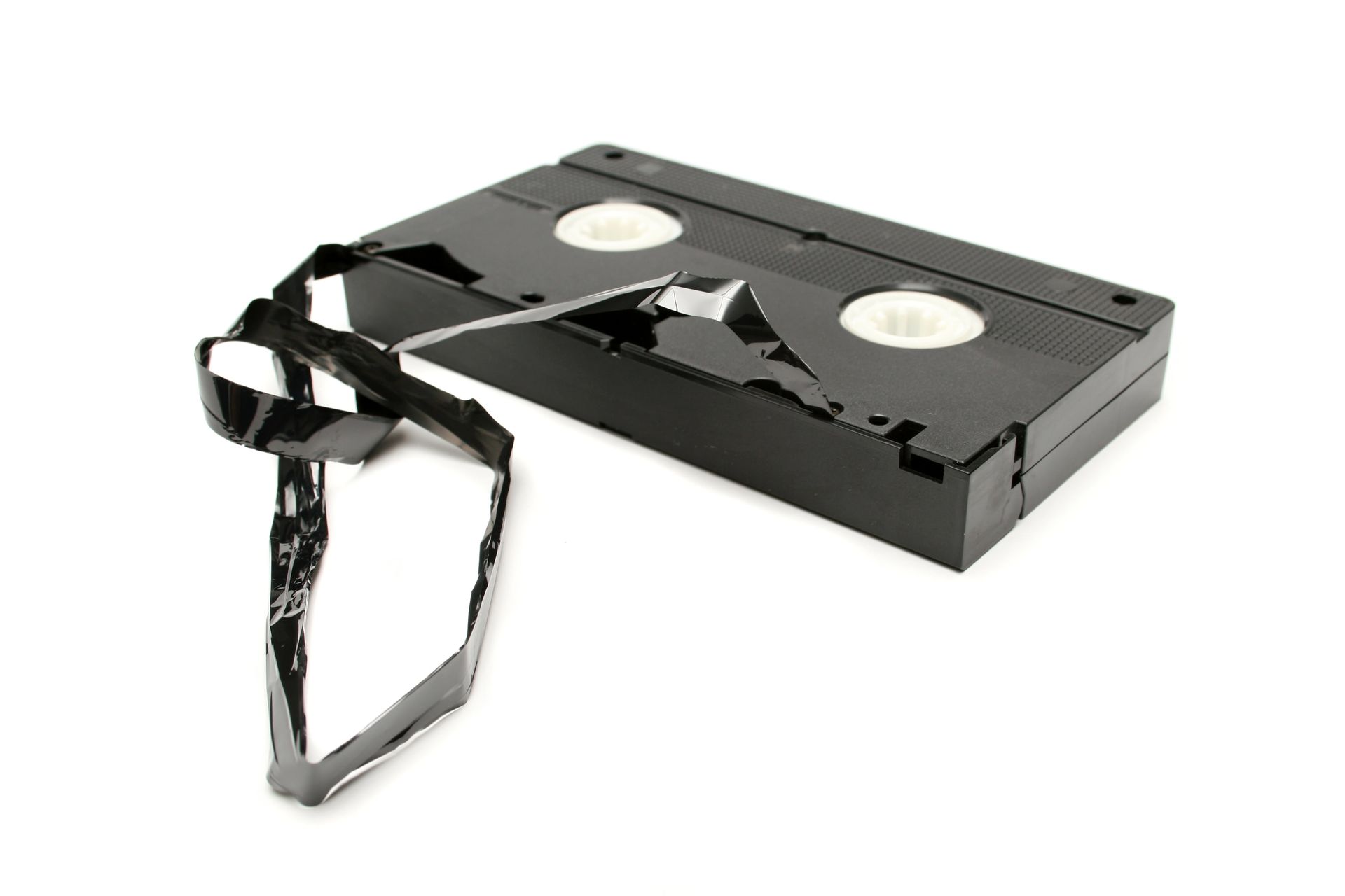 A broken vhs tape on a white background