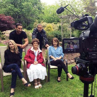 A group of people sitting in chairs in front of a camera