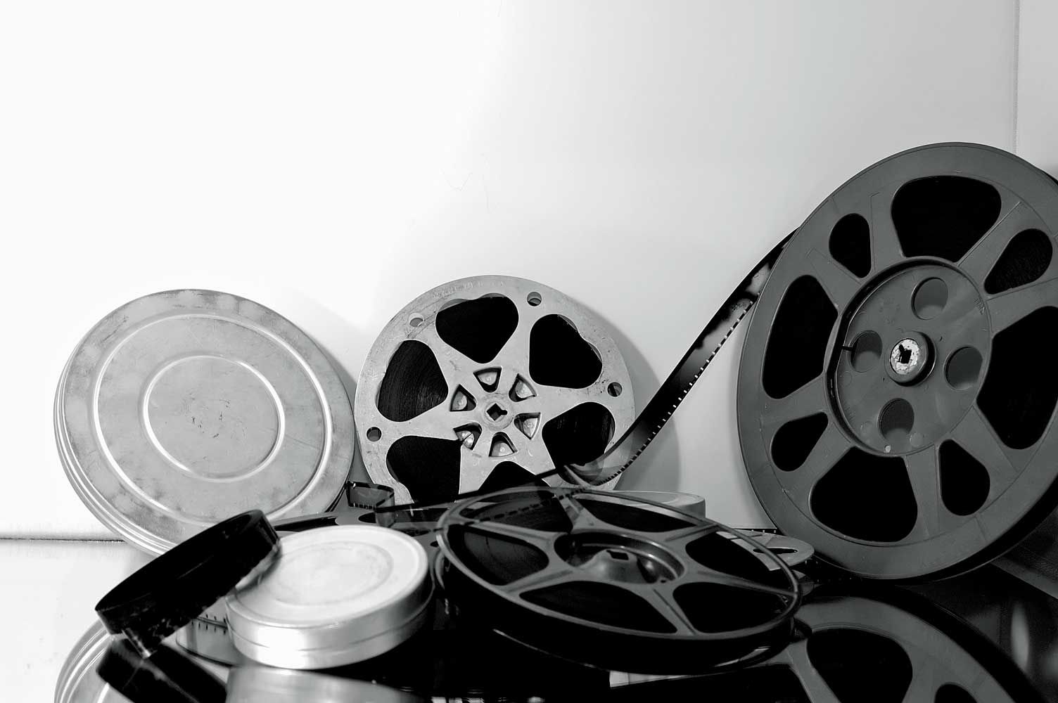 A black and white photo of a pile of film reels