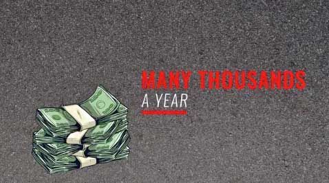 A stack of money is sitting on top of a concrete surface.