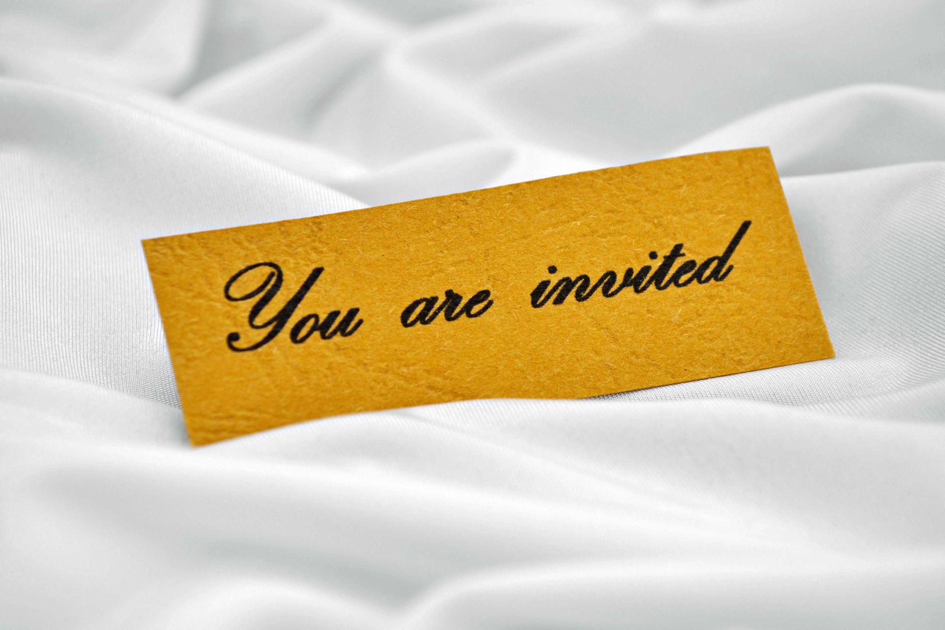 A card that says you are invited on it
