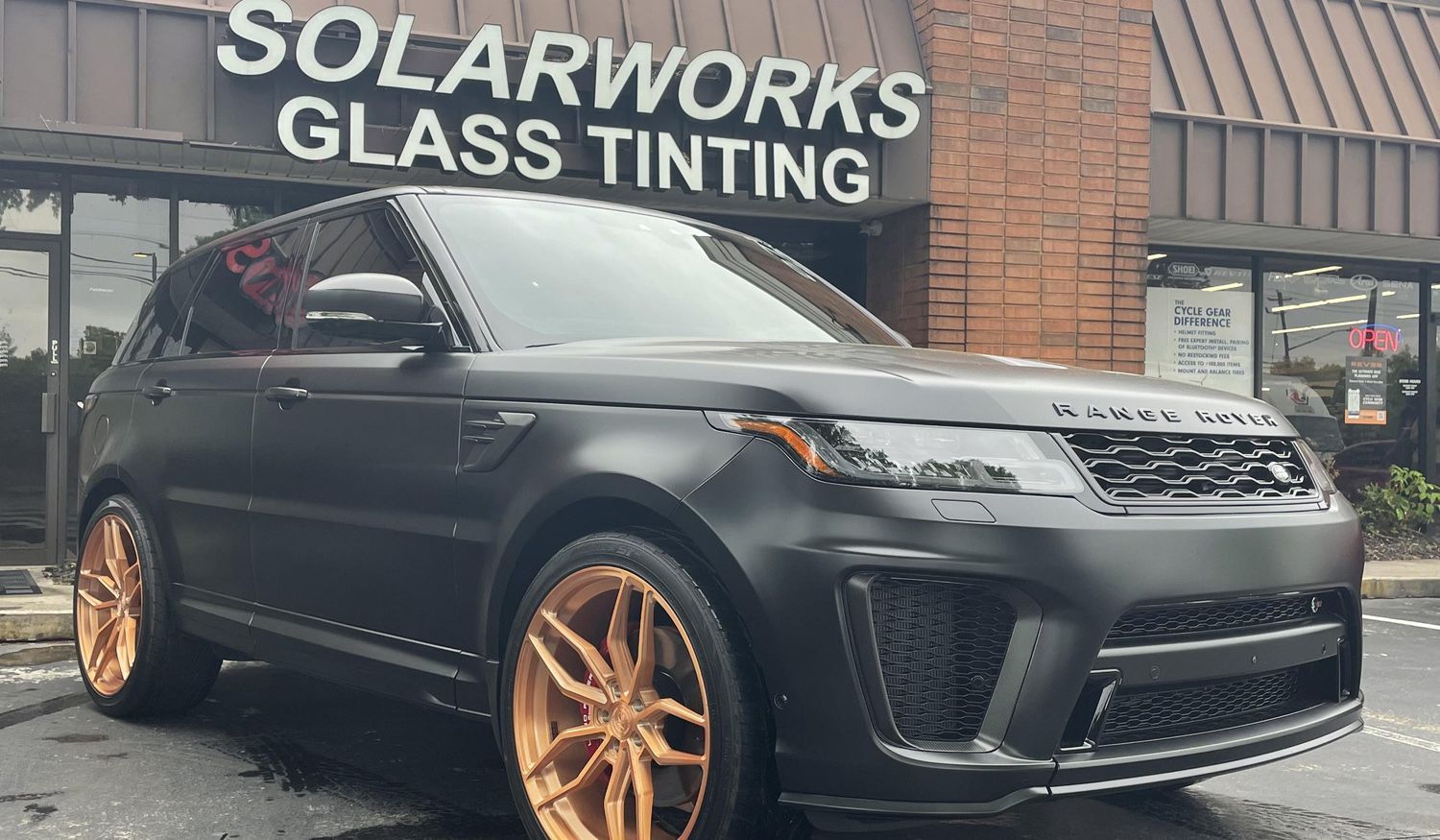 range rover with ceramic coating in front of Solarworks Glass Tinting in Roswell