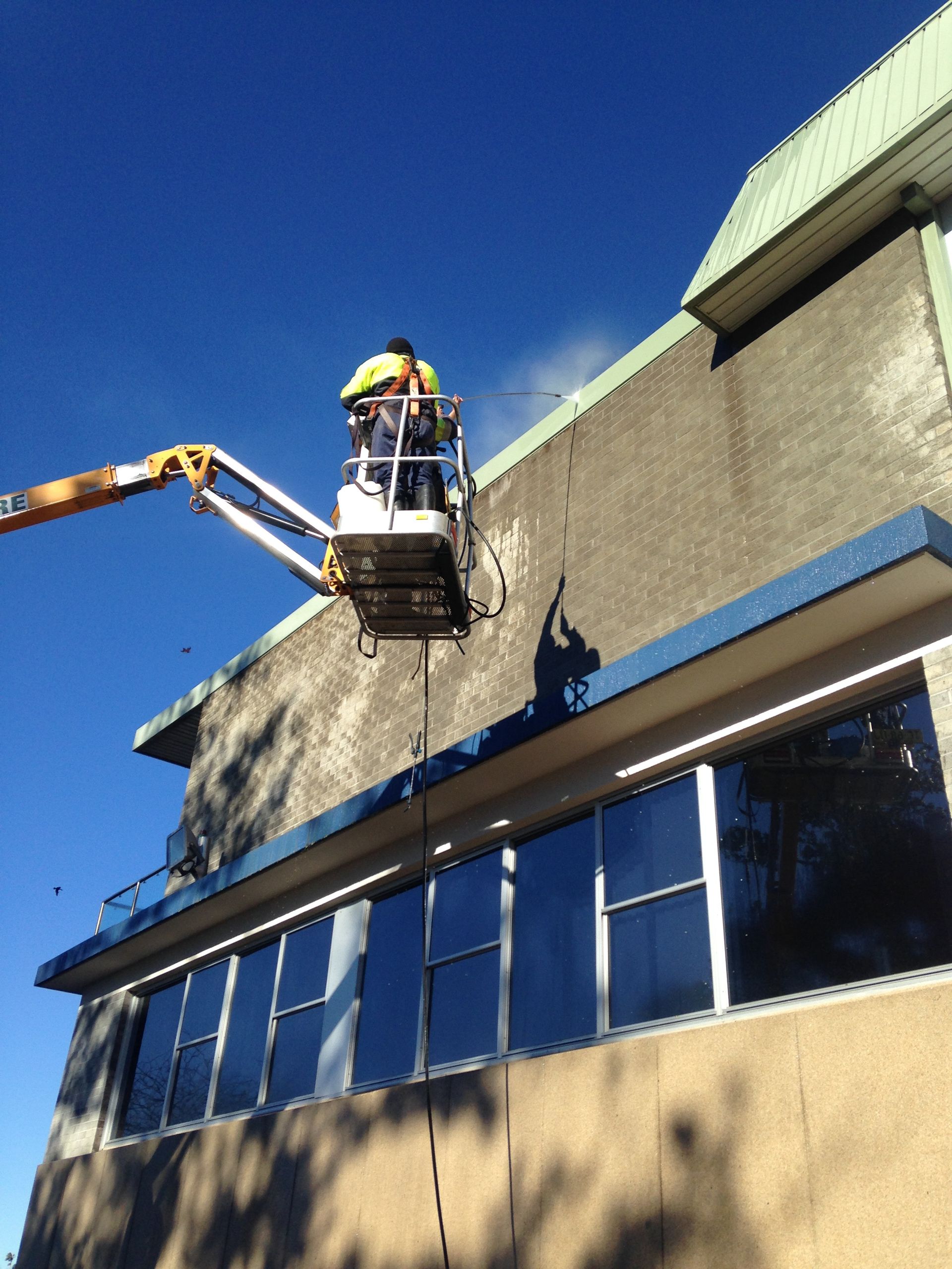 Workers in Lift Cleaning the Facade of Apartment  — Complete Pressure Cleaning in Glen Port Macquarie, NSW