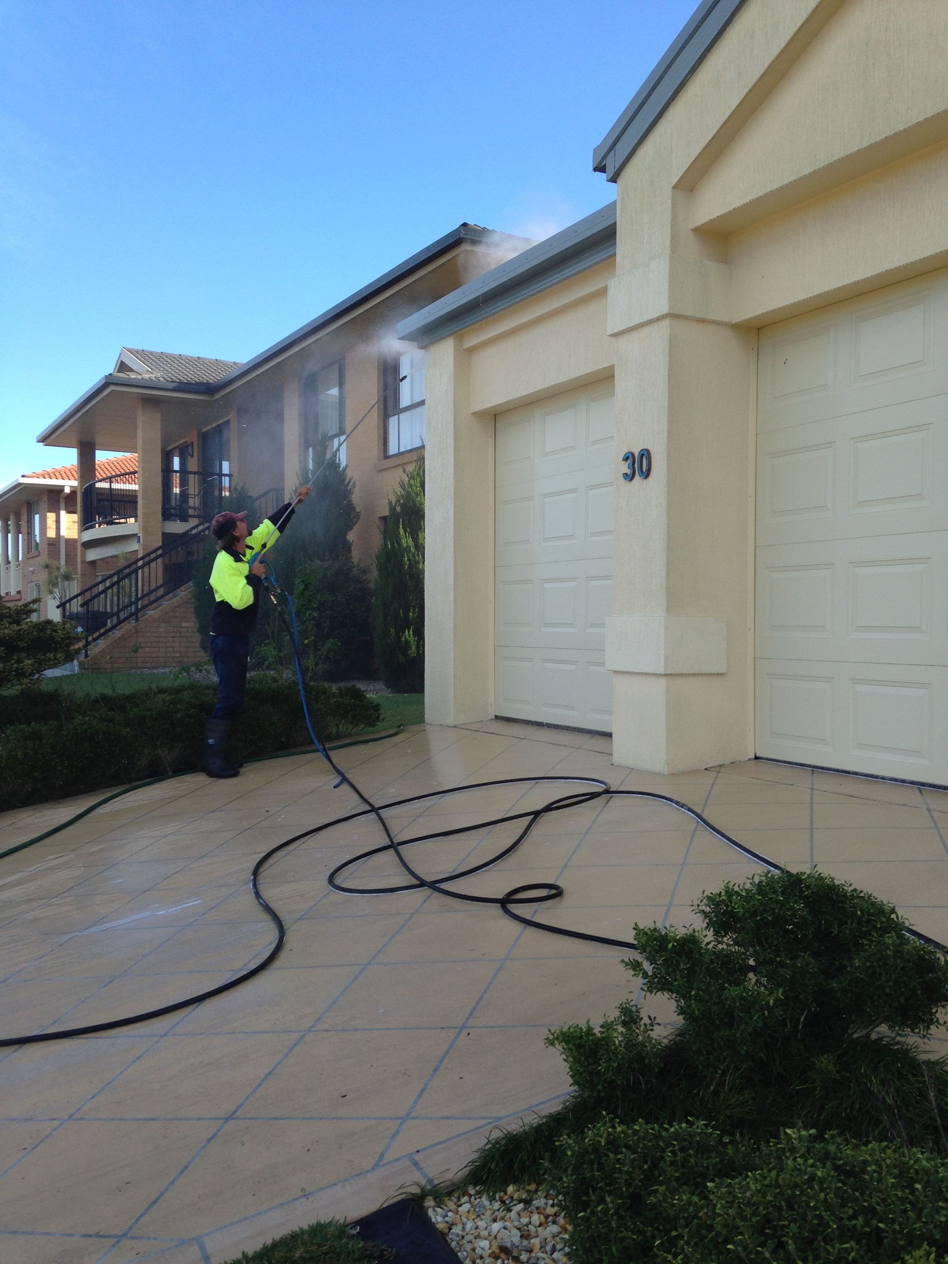 Man Cleaning the  Wall with Pressure Washer — Complete Pressure Cleaning in Glen Port Macquarie, NSW