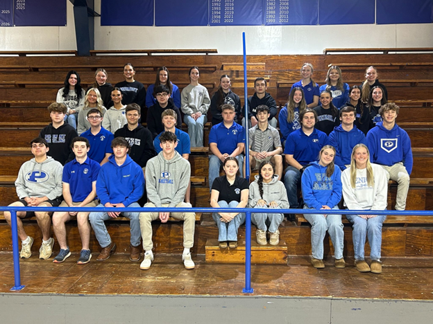 A group of young people are posing for a picture while holding certificates.