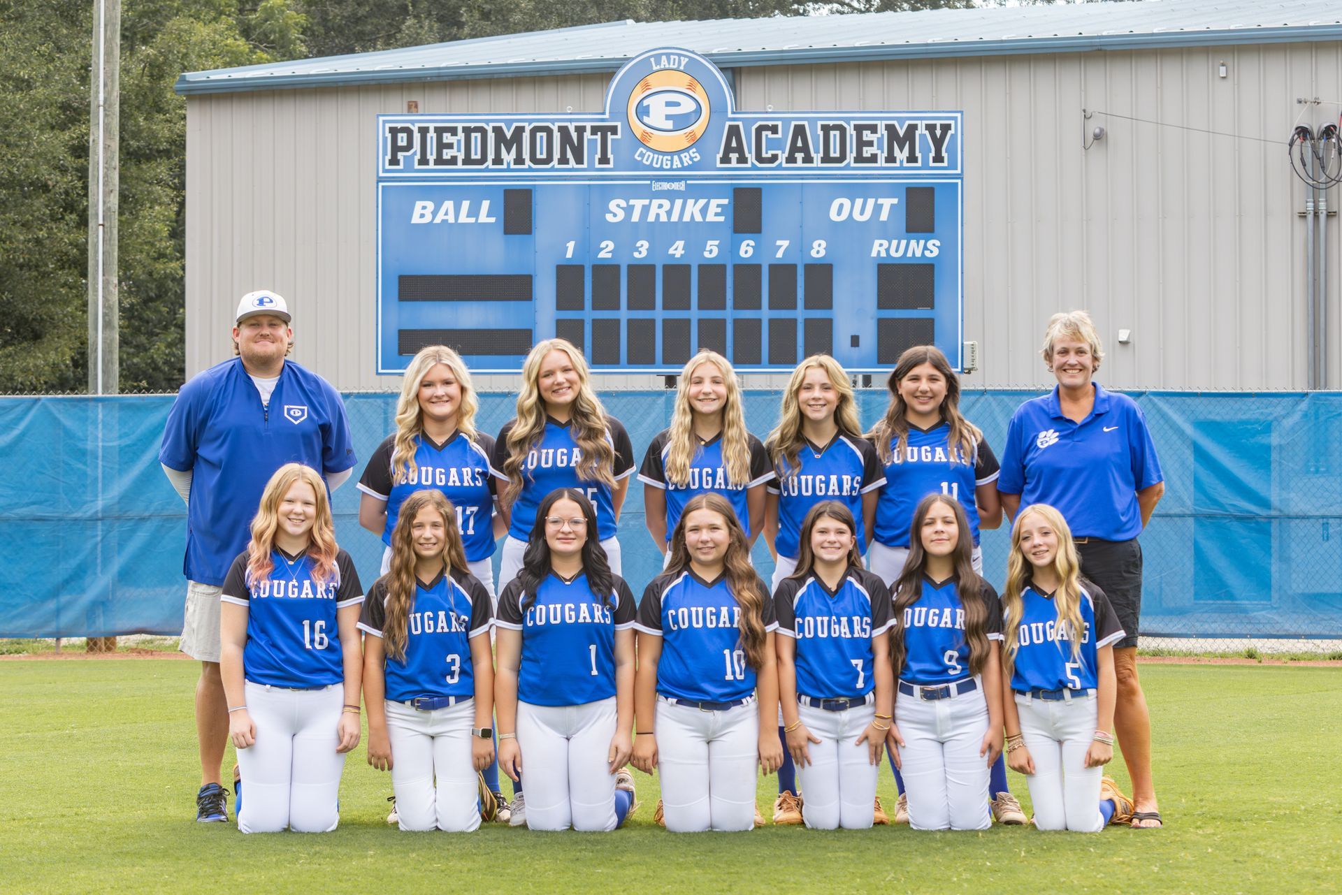 The piedmont softball team is posing for a team photo.