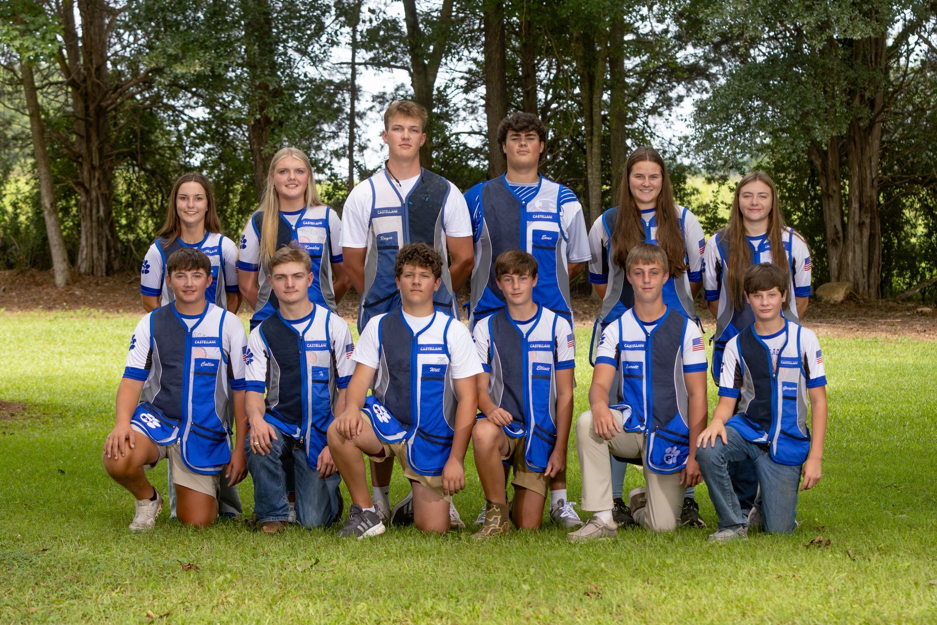 A group of boys are standing in front of a sign that says piedmont clay targets