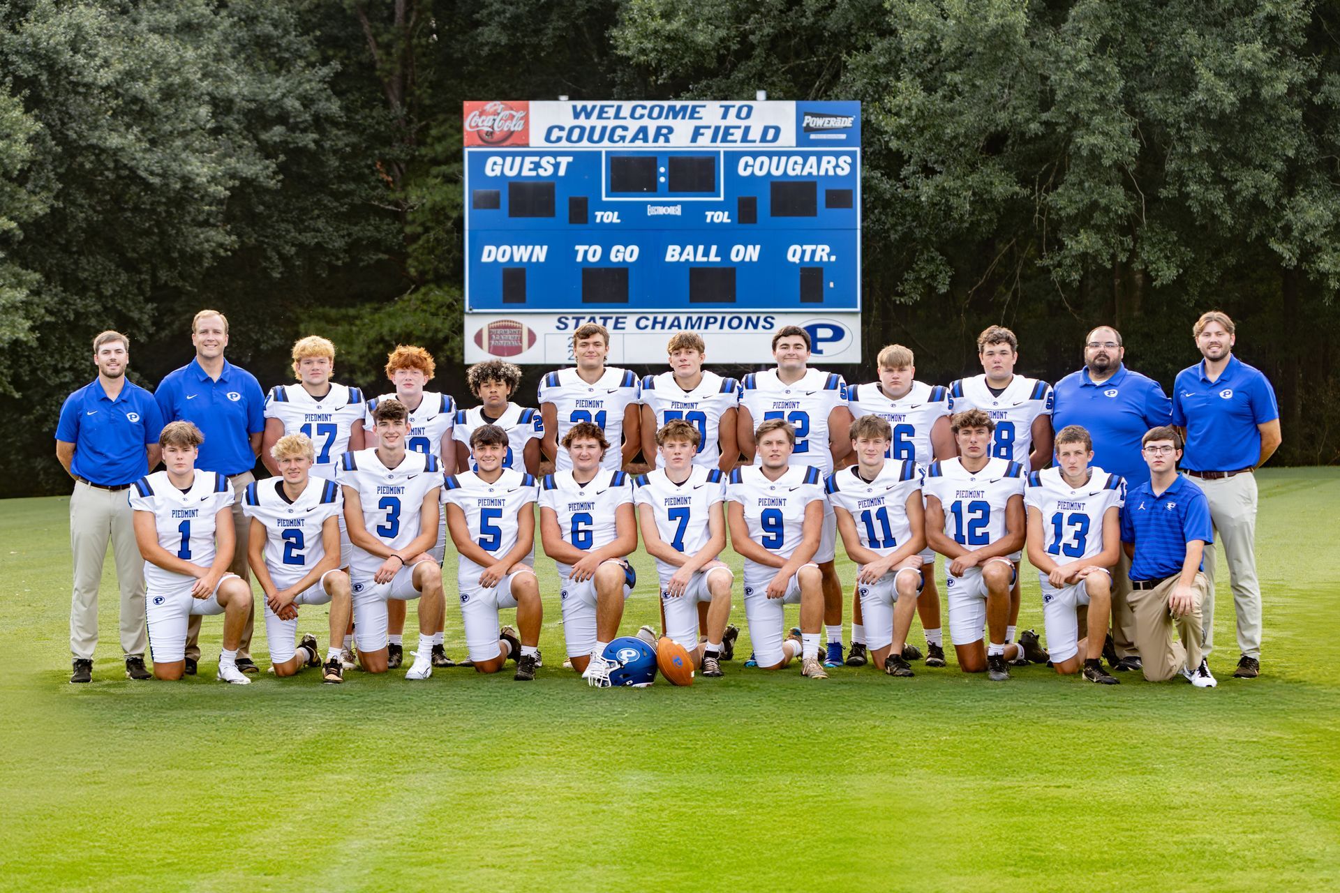 A group of football players are posing for a team photo.