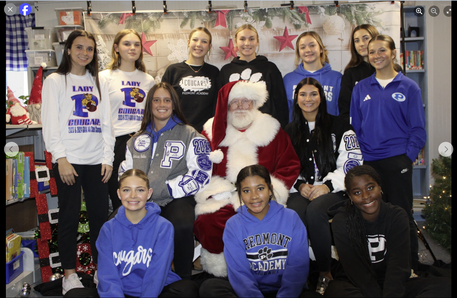 A group of young girls are posing for a picture with santa claus.