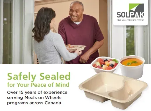 A woman is holding a tray of food in front of a man who is holding a tray of soup