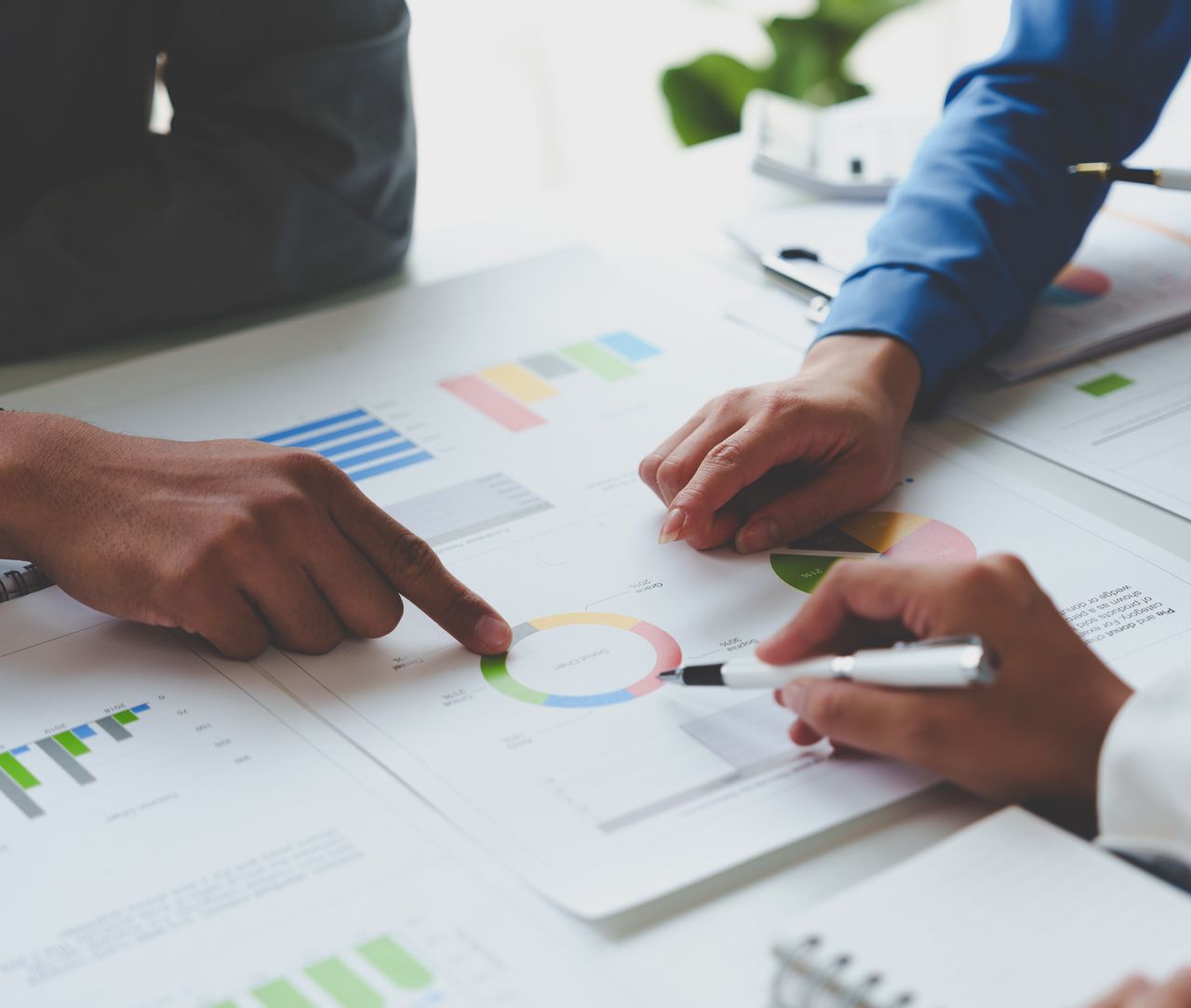 A person is pointing at a graph on a piece of paper