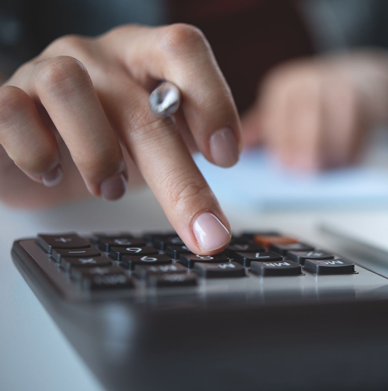 A close up of a person using a calculator