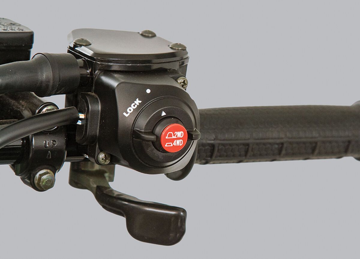 Push button on the handlebar of an ATV.