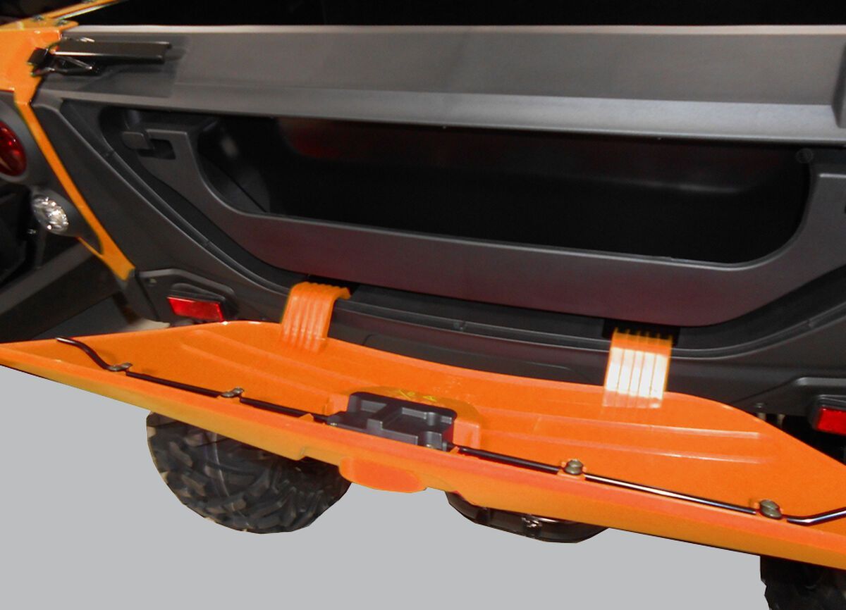a close up of the extra storage room on an orange ATV.