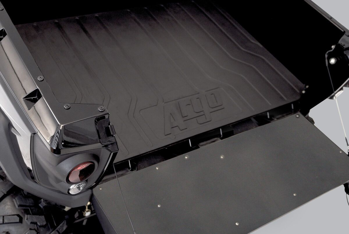 the back of a black ATV cargo box with the word Argo on the mat.