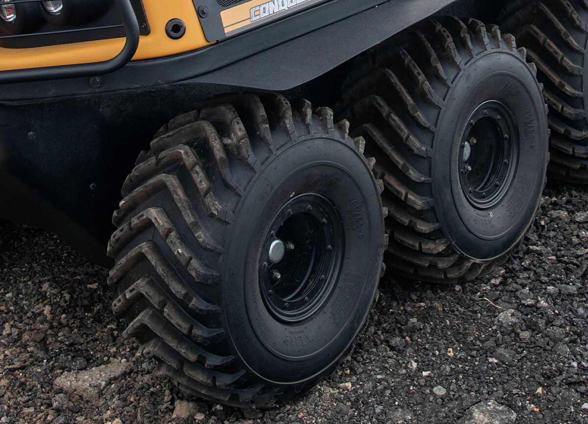 a yellow and black vehicle with the word Conquest on the side