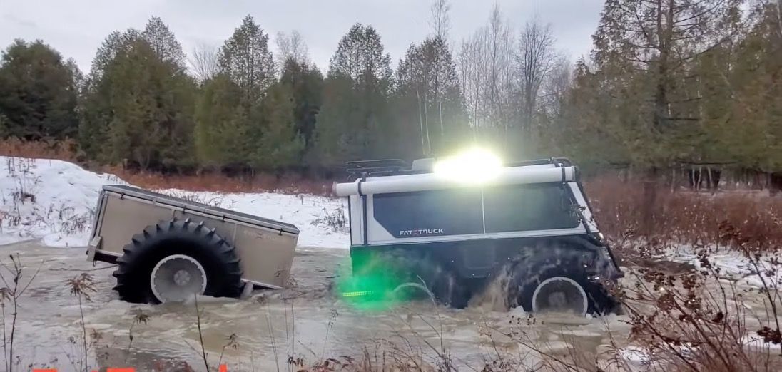 Fat Truck in water with a side LED light shining brightly.
