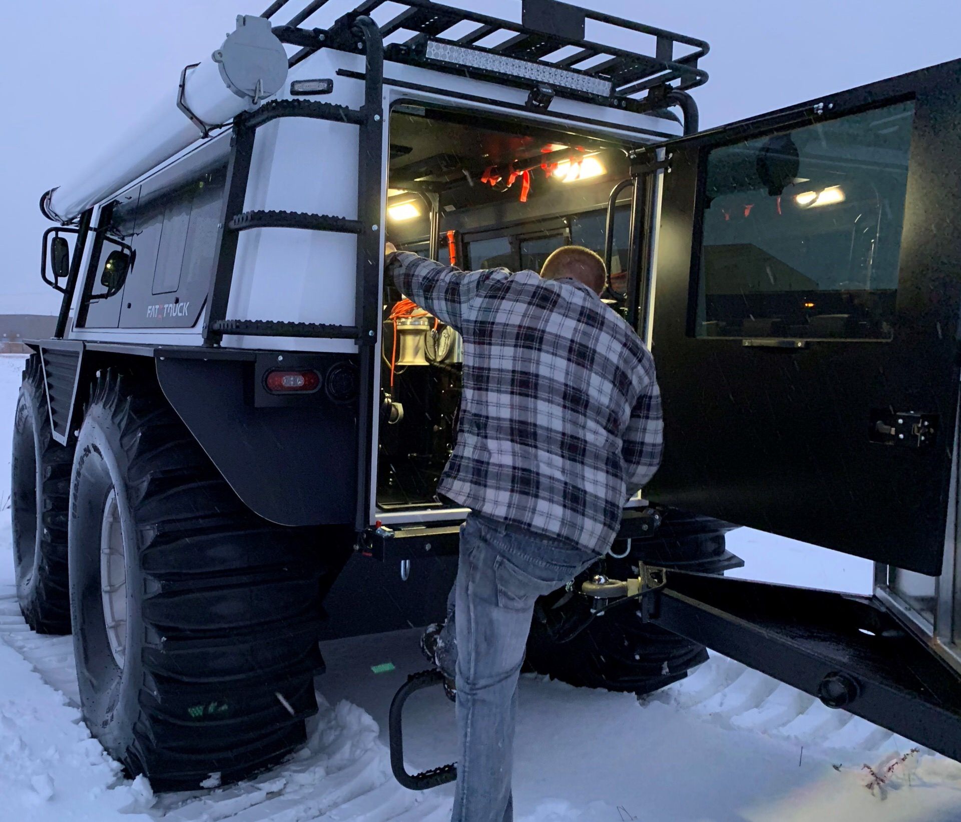 A man entering into a Fat Truck®  from the rear entry.