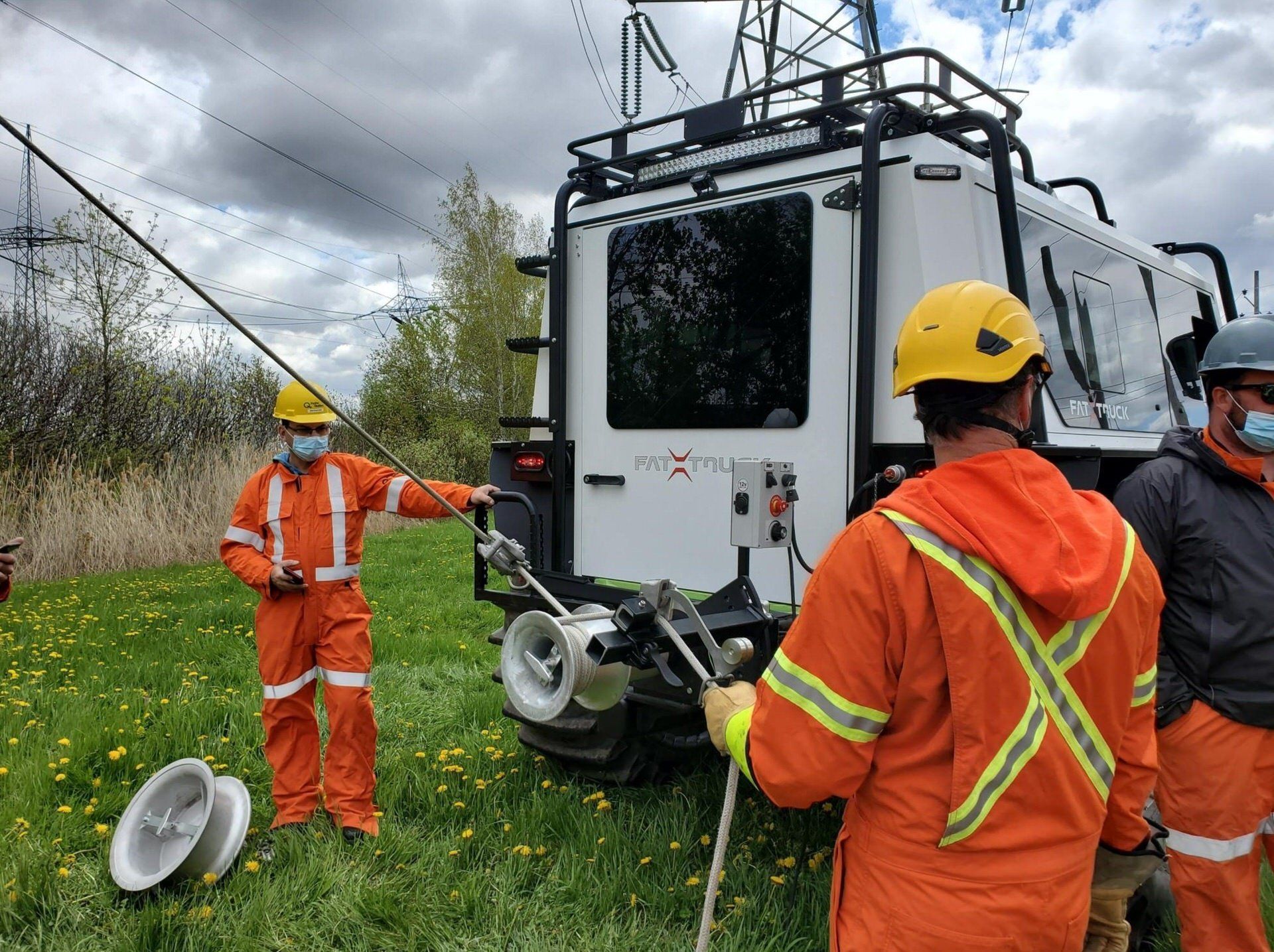 Extreme terrain industrial off-road vehicle called a Fat Truck® . Utility crew of men working onsite