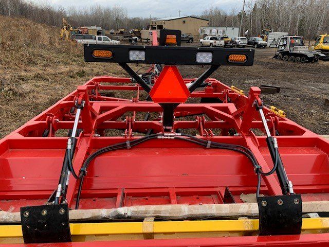 Lighting and safety reflectors are attached to the rear of the trail drag.