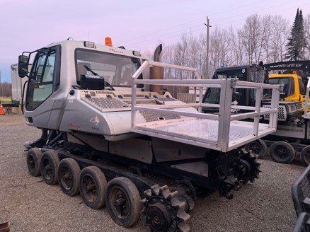 Cargo deck installed on a snow groomer for hauling extra fluids and fuel.