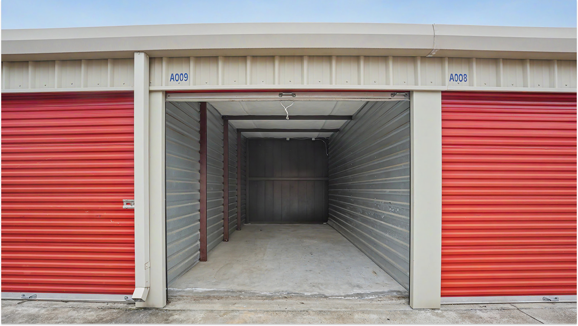 Open storage unit with red roll-up door at Stop N Stor