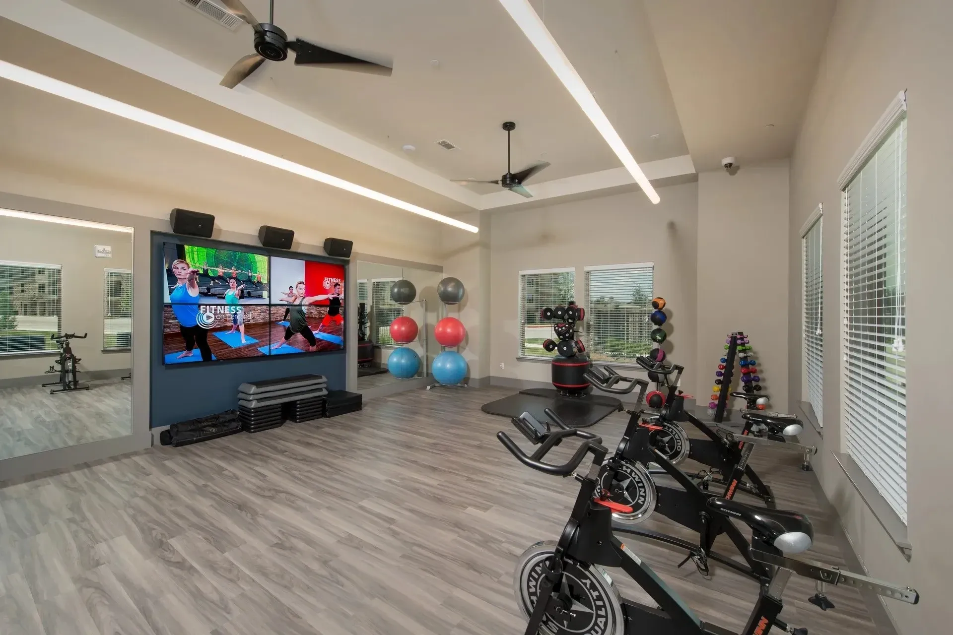Inside view of a fitness center with exercise bikes and workout equipment