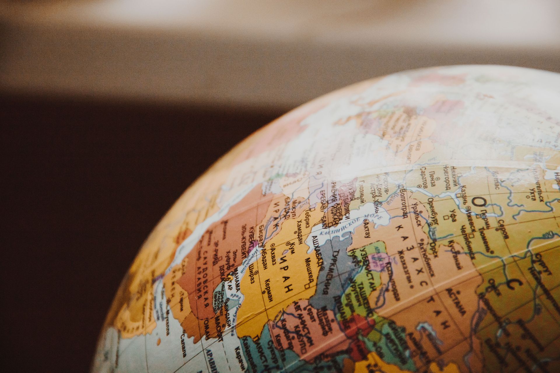 Close-up of a globe showing North America, lit warmly against a blurred background