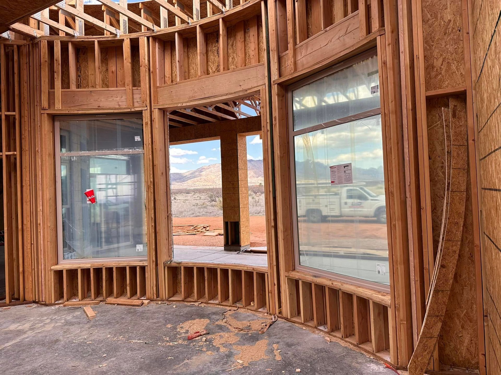 A building under construction with a lot of windows and a truck in the background.