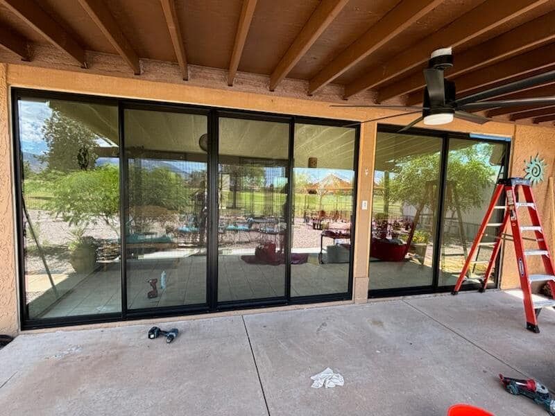 A sliding glass door is being installed on a patio.