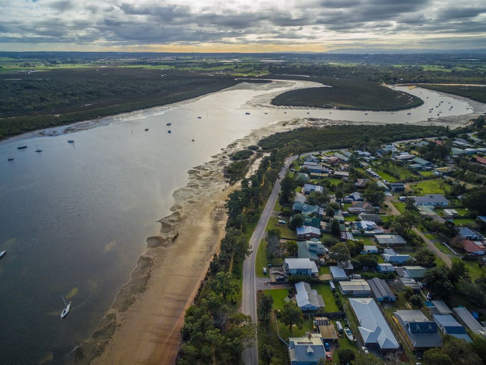 An Aerial View of A River Surrounded by Houses and Trees — Rearden Fencing Pty Ltd in Rutherford, NSW