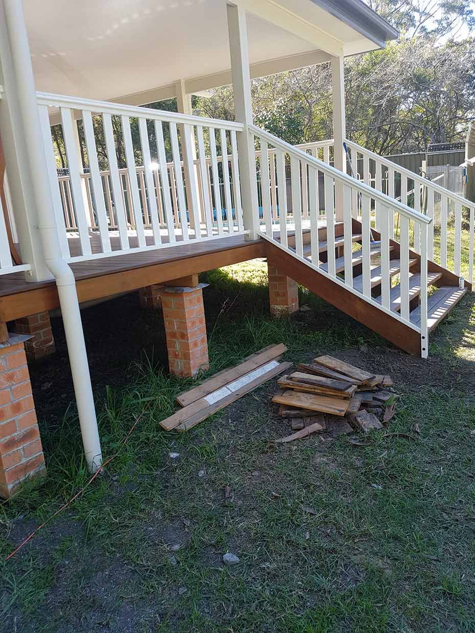 A House With Stairs Leading Up to It and a White Railing — Rearden Fencing Pty Ltd in Toronto, NSW
