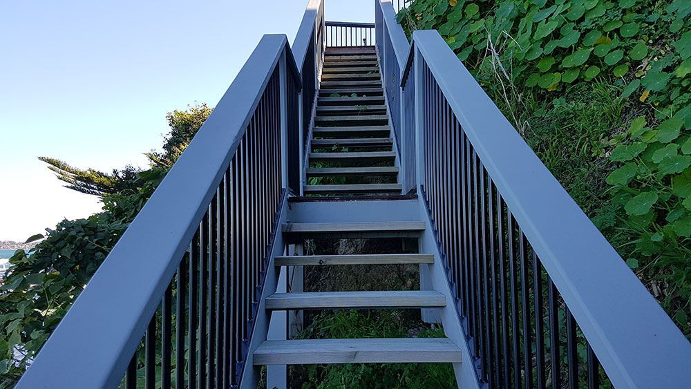 A Set of Stairs With a Railing Going Up a Hill — Rearden Fencing Pty Ltd in Toronto, NSW