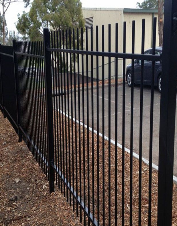 A Black Metal Fence With a Car Parked Behind It — Rearden Fencing Pty Ltd in Toronto, NSW