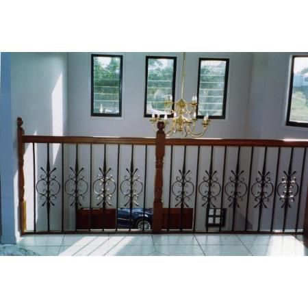 A Staircase With a Wrought Iron Railing and a Chandelier Hanging From the Ceiling — Rearden Fencing Pty Ltd in Toronto, NSW