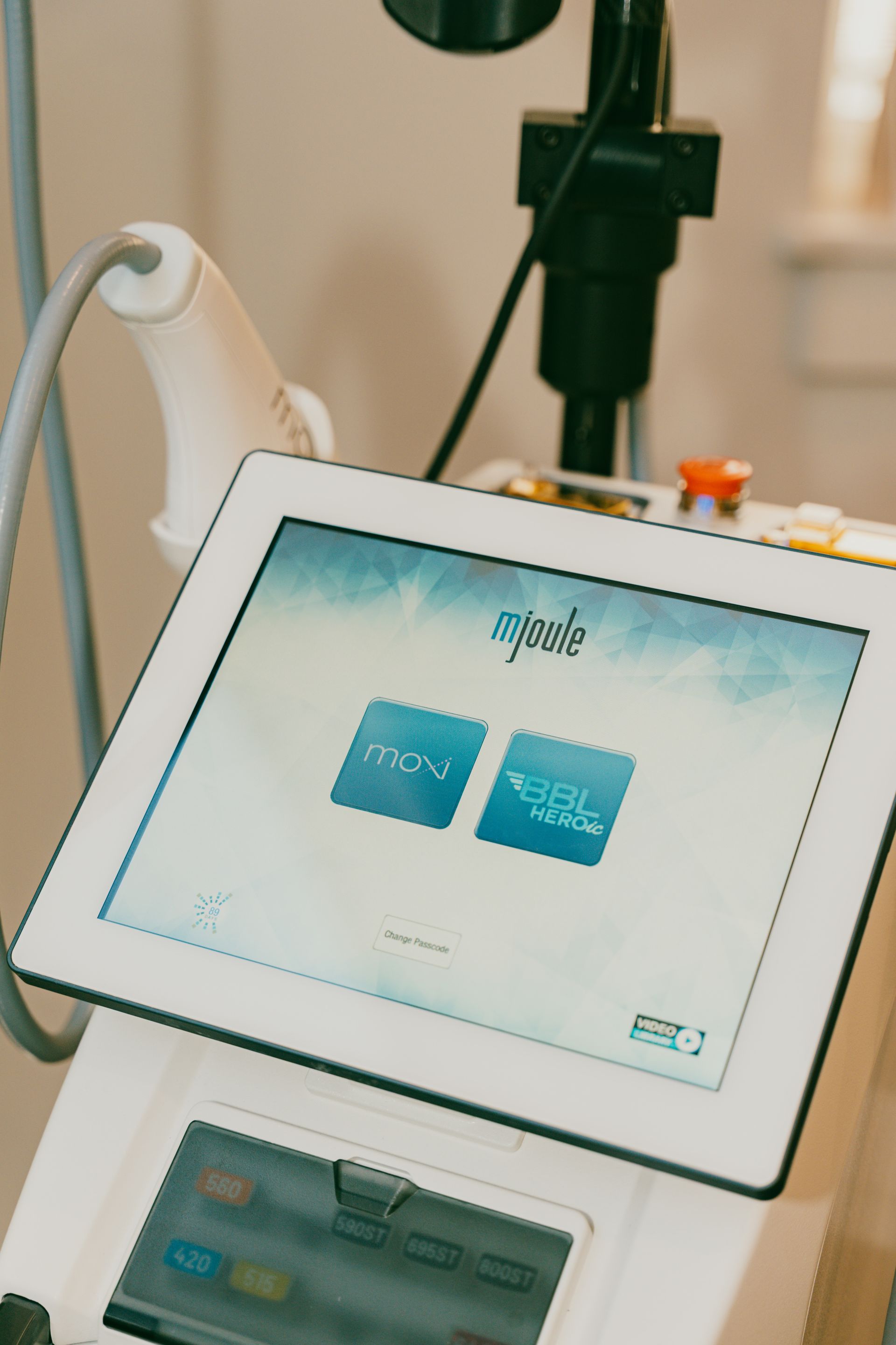 Tablet on a stand showing a blue two-option touchscreen interface in a lab or clinic setting