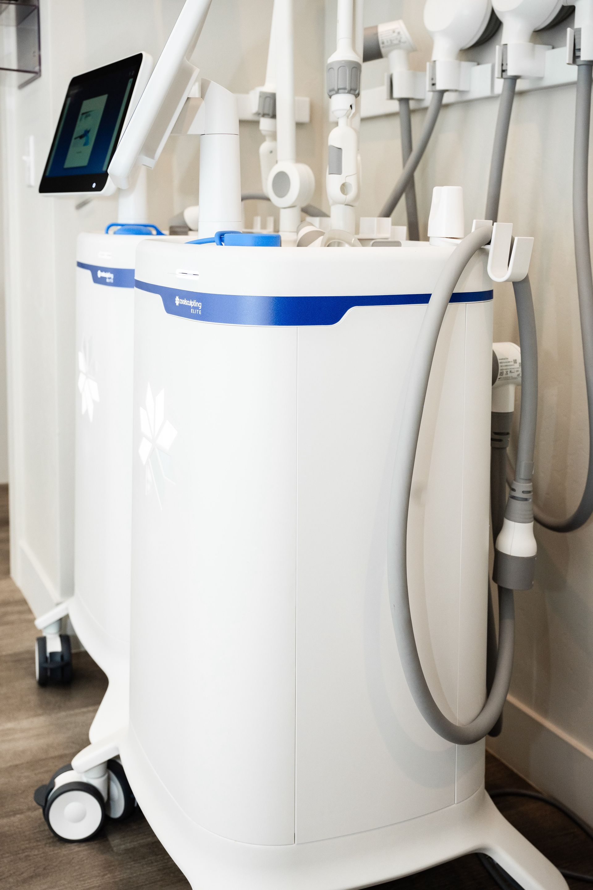 White medical spa machine with attached hoses and wand applicators on wheels in a clinic setting