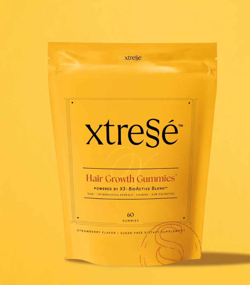 Yellow pouch of xtrese Hair Growth Gummies with orange accents on a yellow background