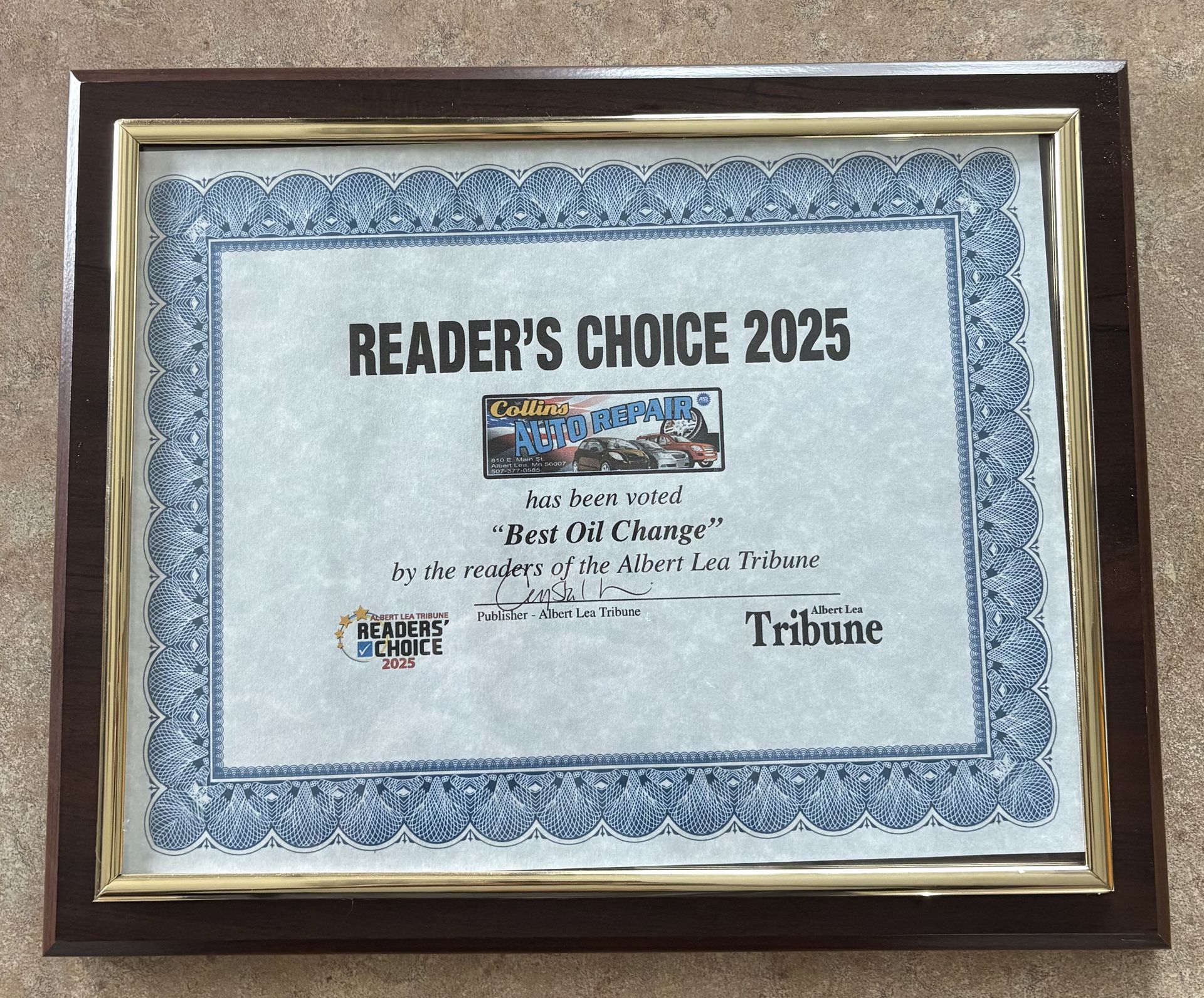 Framed blue-bordered Readers’ Choice 2025 award certificate from the Tribune